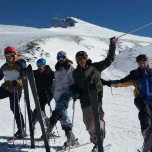 Grupo de alumnos con esquís en una cresta nevada de Sierra Nevada